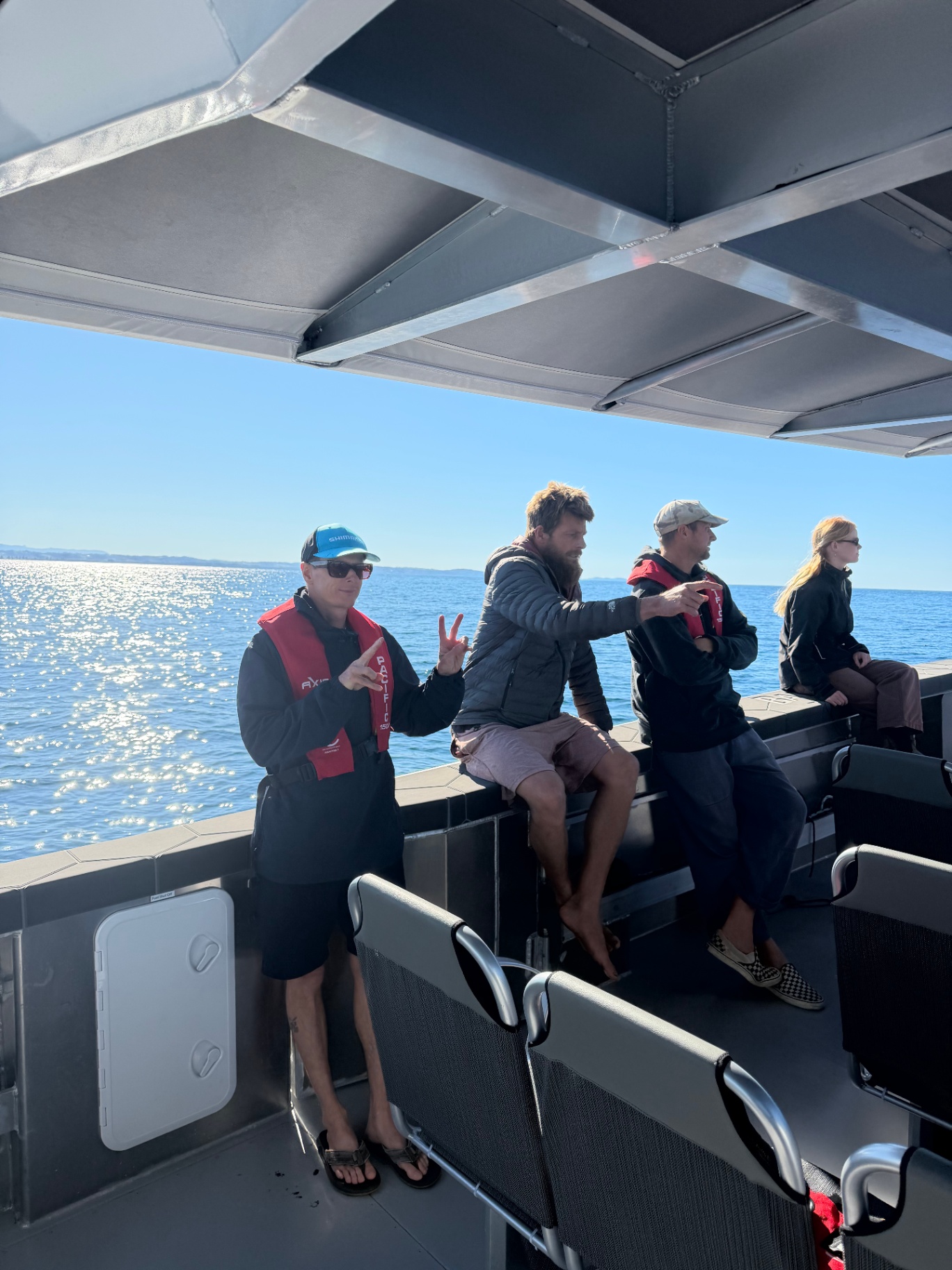 Guests on the open deck of Cetacean One watching the water